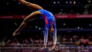 Simone BIles competes on beam