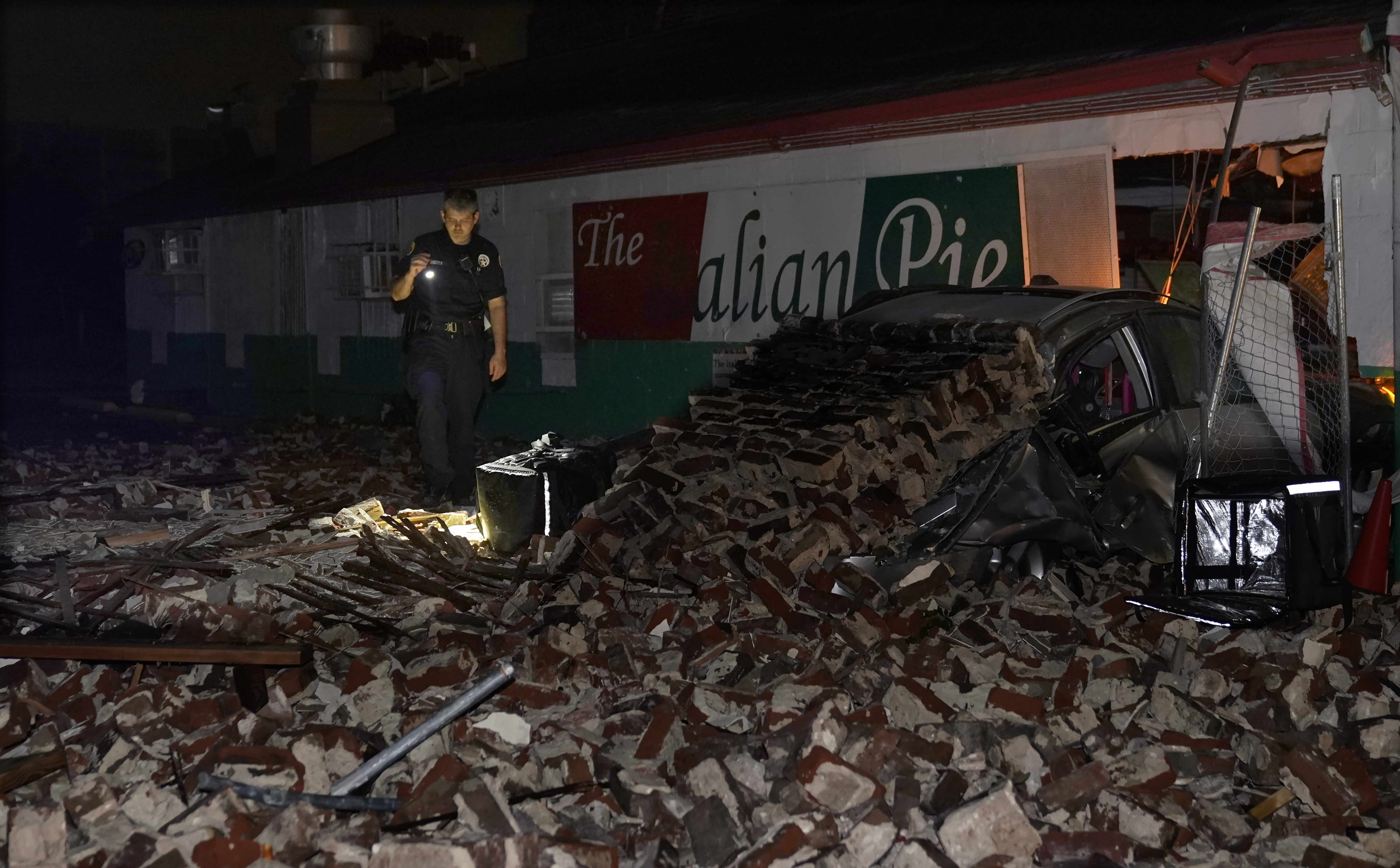 New Orleans police look through debris after a building collapsed from the effects of Hurricane Ida, Monday, Aug. 30, 2021, in New Orleans, La.