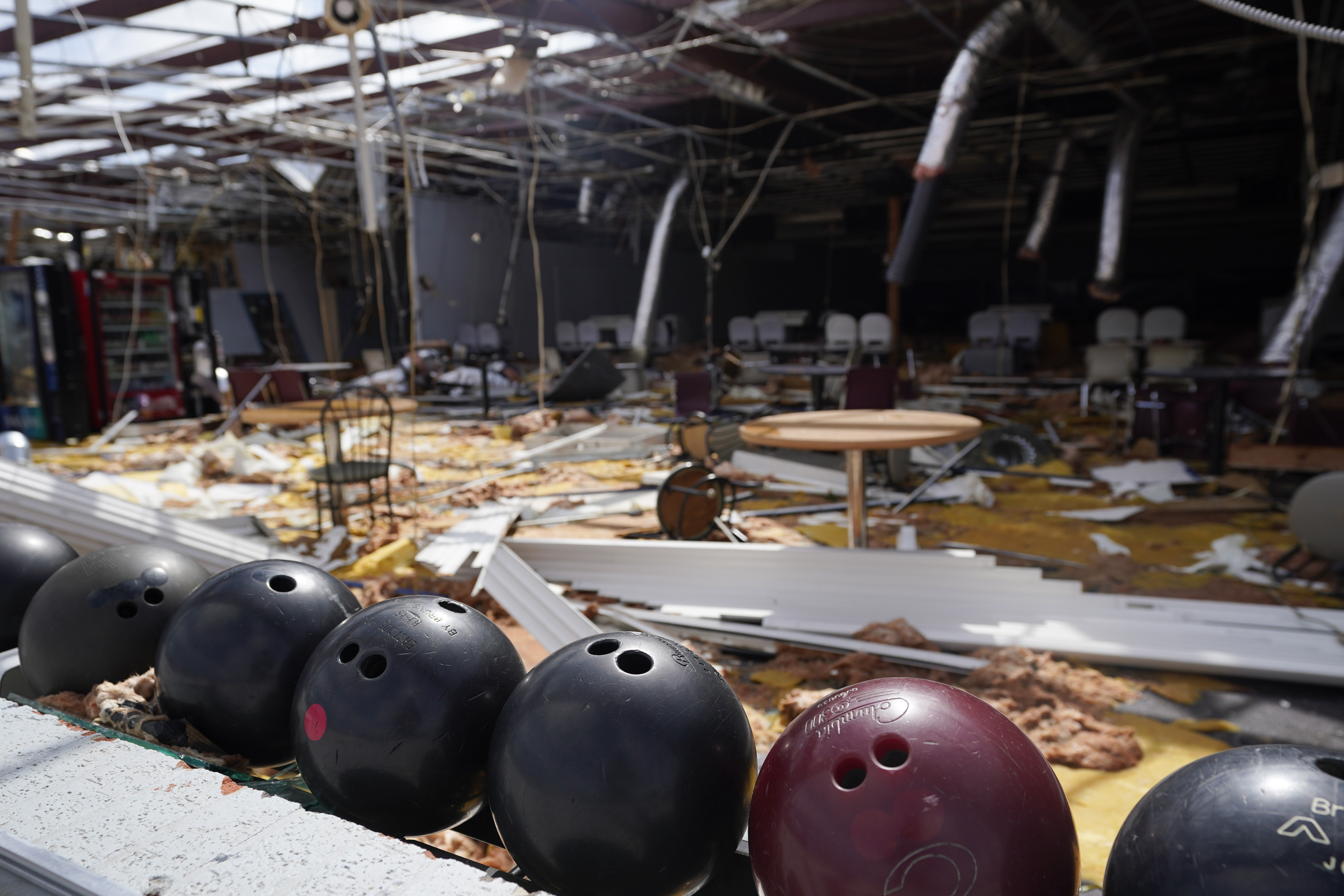 In the aftermath of Hurricane Ida, bowling balls sit in a rack at the heavily damaged Bowl South of Louisiana Tuesday, Aug. 31, 2021, in Houma, La.