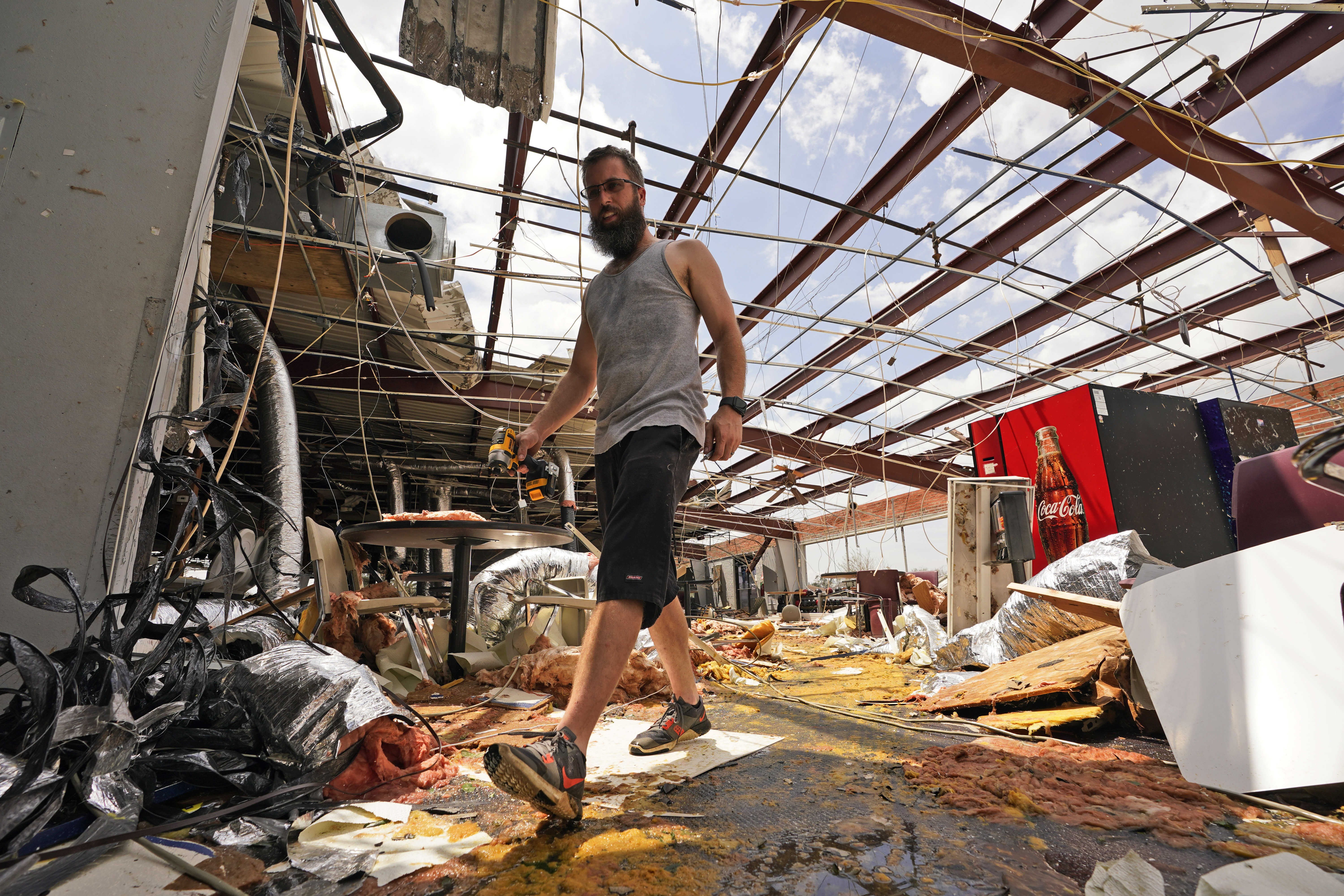 Jason Ledet relieves a tool as he works in a destroyed bowling alley as they try to recover from the effects of Hurricane Ida Tuesday, Aug. 31, 2021, in Houma, La.