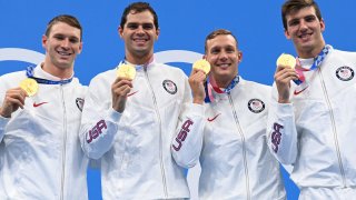 Gold medallists (from L) USA's Ryan Murphy, USA's Michael Andrew, USA's Caeleb Dressel and USA's Zach Apple pose on the podium after the final of the men's 4x100m medley relay swimming event during the Tokyo 2020 Olympic Games at the Tokyo Aquatics Centre in Tokyo on August 1, 2021.