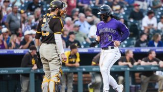 DENVER, CO – AUGUST 16: Connor Joe #9 of the Colorado Rockies scores against the San Diego Padres on a two-run double off the bat of Trevor Story of the Colorado Rockies in the third inning at Coors Field on August 16, 2021 in Denver, Colorado. (Photo by Michael Ciaglo/Getty Images)