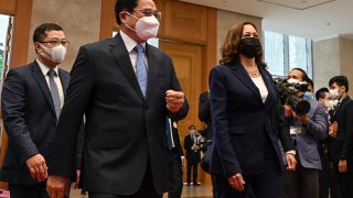 US Vice President Kamala Harris (R) walks with Vietnam's Prime Minister Pham Minh Chinh