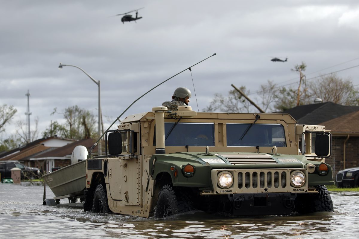 A National Guard vehicle drives through floodwater left behind by Hurricane Ida in LaPlace, Louisiana on Monday, Aug. 30, 2021.