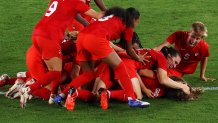 Julia Grosso #7 of Team Canada celebrates with team mates after scoring their side's winning penalty in the penalty shoot out in the Women's Gold Medal Match between Canada and Sweden on day fourteen of the Tokyo 2020 Olympic Games at International Stadium Yokohama on Aug. 6, 2021 in Yokohama, Kanagawa, Japan.