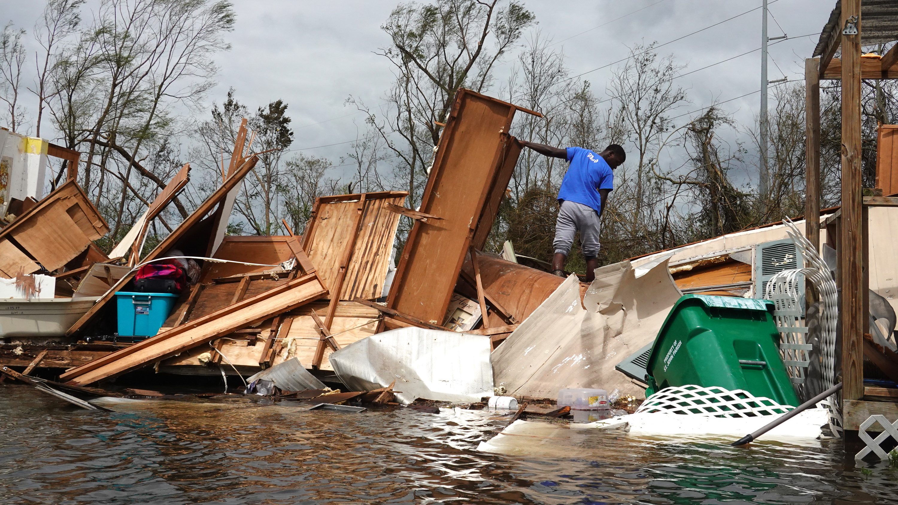 Alonzo Lewis rescues items from his mother’s home after it was destroyed by Hurricane Ida on Aug. 30, 2021, in Laplace, Louisiana.