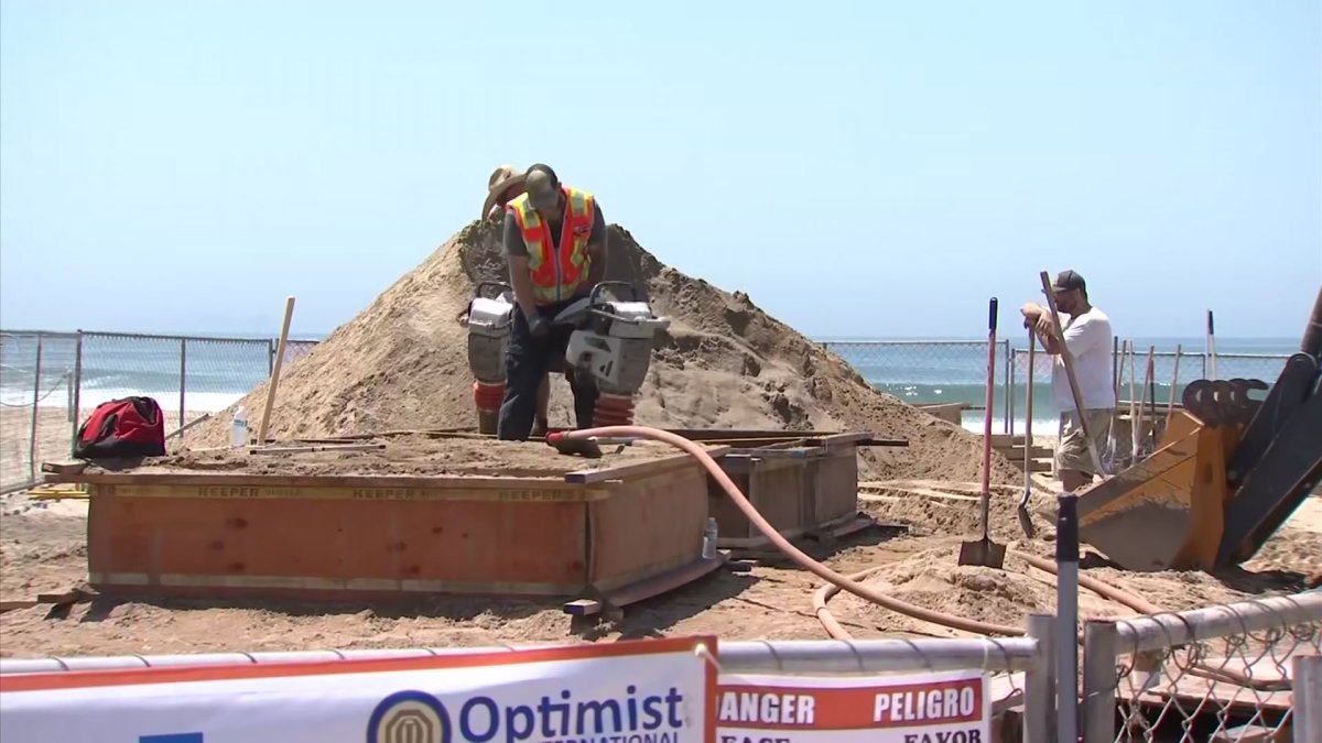 Artists Sculpting Giant Pile of Sand Into Largest Sandcastle