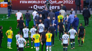 Players leave the area after the World Cup Qualifier game between Brazil and Argentina was suspended