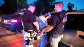 U.S. Immigration and Customs Enforcement officers carry out a raid as part of Operation Cross Check in Sherman, Texas, on June 20, 2019.