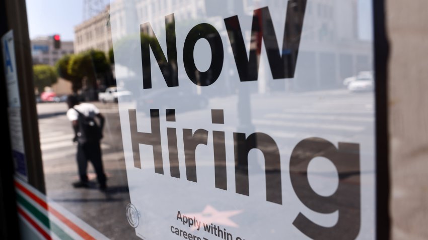 A ‘Now Hiring’ sign is posted at a 7-Eleven store on August 06, 2021 in Los Angeles, California.