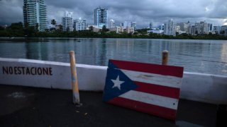 A wooden Puerto Rican flag is displayed on the dock of the Condado lagoon
