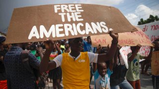 People protest for the release of kidnapped missionaries near the Ohio-based Christian Aid Ministries headquarters in Titanyen, north of Port-au-Prince, Haiti,