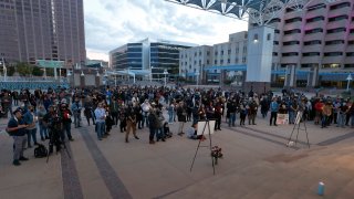 A large crowd of movie industry workers and New Mexico residents attend a candlelight vigil to honor cinematographer Halyna Hutchins in downtown Albuquerque, N.M.