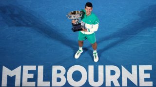 Serbia's Novak Djokovic holds the Norman Brookes Challenge Cup after defeating Russia's Daniil Medvedev in the men's singles final at the Australian Open tennis championship in Melbourne, Australia, Sunday, Feb. 21, 2021.