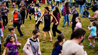 Kerri Helme, center, of the Mashpee Wampanoag Tribal Nation leads attendees in dance during a gathering marking Indigenous Peoples Day at Penn Treaty Park in Philadelphia, Monday, Oct. 11, 2021.