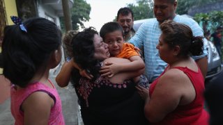 Family members embrace Leo Jeancarlo de Leon, 6, after he returned home from the United States on Aug. 8, 2018, near San Marcos, Guatemala. He had been separated from his mother, Lourdes de Leon, for nearly three months as a result of the Trump administration's "zero tolerance" border policy after they were taken into custody by the U.S. Border Patrol. Lourdes was deported and Leo was held at the Cayuga Centers in New York City until he was flown back to Guatemala with eight other children.