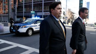 William Ferguson, left, former women's volleyball coach at Wake Forest University, is pictured outside the John Joseph Moakley United State Courthouse in Boston on March 25, 2019.