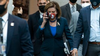House Speaker Nancy Pelosi of Calif., talks on her phone as she arrives for a meeting with House Democrats, Oct. 1, 2021, on Capitol Hill in Washington.