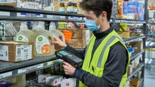 A Kroger (parent company of Ralphs and Food 4 Less) logistics employee at work.