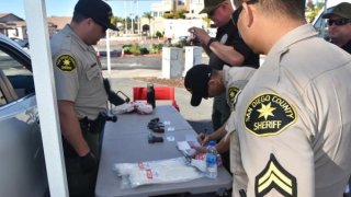 SDSO Officers documenting guns turned in for the gun buy back event