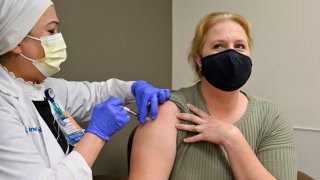 Nurse Mary Ezzat administers a Pfizer COVID-19 booster shot to Jessica M. at UCI Medical Center in Orange, CA, on Thursday, August 19, 2021.