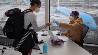 The passenger of a flight from South Africa is tested for Covid-19 at Amsterdam Schiphol airport on December 2, 2021 in Amsterdam, Netherlands.