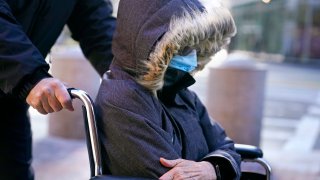 Elisabeth Kimmel, of La Jolla, Calif., is wheeled into federal court for a sentencing hearing, Thursday, Dec. 9, 2021, in Boston.