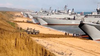 FILE – This file frame from a video released on April 23, 2021, by Russian Defense Ministry Press Service shows, Russian troops board landing vessels after drills in Crimea.