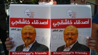 People hold posters of slain Saudi journalist Jamal Khashoggi, near the Saudi Arabia consulate in Istanbul, marking the two-year anniversary of his death, Friday, Oct. 2, 2020. The gathering was held outside the consulate building, starting at 1:14 p.m. (1014 GMT) marking the time Khashoggi walked into the building where he met his demise.