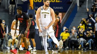 ANN ARBOR, MICHIGAN – DECEMBER 04: Hunter Dickinson #1 of the Michigan Wolverines reacts after shooting a 3-pointer against the San Diego State Aztecs during the first half at Crisler Arena on December 04, 2021 in Ann Arbor, Michigan. (Photo by Nic Antaya/Getty Images)