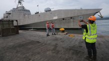 This photo taken on June 29, 2019 shows Philippine navy personnel taking photos in front of USS Montgomery (LCS 8), an Independence-class littoral combat ship of the US Navy, in Davao City on the southern island of Mindanao for a port visit. (Photo by Manman Dejeto / AFP) (Photo credit should read MANMAN DEJETO/AFP via Getty Images)