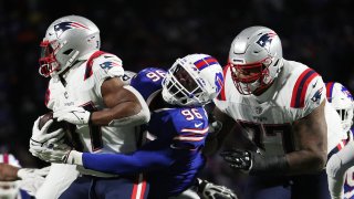 Boogie Basham #96 of the Buffalo Bills tackles Damien Harris #37 of the New England Patriots during the second quarter at Highmark Stadium on December 06, 2021 in Orchard Park, New York.