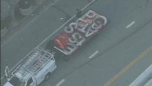 NewsChopper4 Alpha captures crews removing the iconic Staples Center lettering and logos from the outside of the stadium, to make way for its new identity as the Crypto.com Arena.