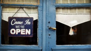 Open sign on the door of an old French bistro
