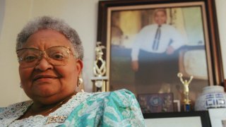 Mamie Till Mobley stands before a portrait of her slain son, Emmett Till, in her Chicago home on July 28, 1995. Since Emmett's lynching 40 years ago, Mobley has been committed to making sure that his death is remembered and never repeated. Till was kidnapped, tortured and lynched for allegedly whistling at a white woman in a small Mississippi town.