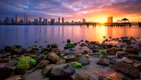 A surreal sunrise of downtown San Diego skyline taken from Coronado