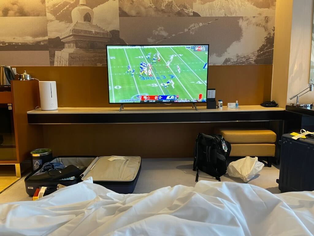 A TV in a hotel room in Beijing displays a football game between the San Francisco 49ers and the LA Rams, Jan. 30, 2022.