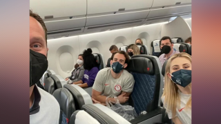 Steven Luke (left) takes a selfie with Timonthy LeDuc (middle) and Ashley Cain-Gribble (right) on a flight to Beijing, Jan. 29, 2022.