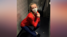Team USA figure skater Mariah Bell exercises on a plane to Beijing for the 2022 Winter Olympics, Jan. 29, 2022.