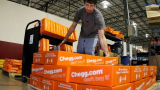 James Tahaney loads textbooks on to a pallet in preparation for shipping at the Chegg warehouse in Shepherdsville, Kentucky, April 29, 2010.