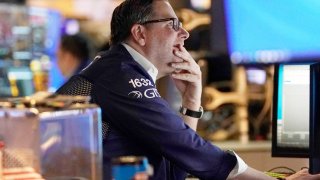 Traders work on the floor of the New York Stock Exchange at the opening bell on February 22 2022, in New York.