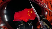 The Chinese national flag is raised during the opening ceremony of the 2022 Winter Olympics, Friday, Feb. 4, 2022, in Beijing.