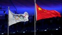 The Chinese and Olympic flags fly during the opening ceremony of the 2022 Winter Olympics, Friday, Feb. 4, 2022, in Beijing.
