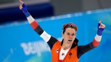 Ireen Wust of the Netherlands reacts after winning her heat and breaking an Olympic record in the women's speedskating 1,500-meter race