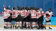 Canada players celebrate after a win against the United States during a preliminary round women's hockey game at the 2022 Winter Olympics, Feb. 8, 2022, in Beijing, China.
