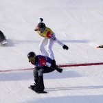 United States' Lindsey Jacobellis (5) reacts as she crosses the finish line followed by France's Chloe Trespeuch (8), United States' Stacy Gaskill (4), and Italy's Michela Moioli (1) during the Women's Cross Finals at the 2022 Winter Olympics, Feb. 9, 2022, in Zhangjiakou, China.