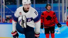 United States' Kenny Agostino (11) celebrates after scoring a goal against Canada during a preliminary round men's hockey game at the 2022 Winter Olympics, Feb. 12, 2022, in Beijing.