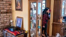 Mary Risling stands near a photo of her missing sister, Emmilee Risling, at the family home