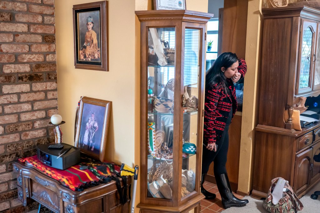 Mary Risling stands near a photo of her missing sister, Emmilee Risling, at the family home