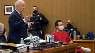 Scott Peterson, seated at right, listens as attorney Pat Harris, standing, speaks during a hearing at the San Mateo County Superior Court